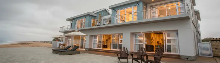 The Winston Beach House seen from the beach at dusk